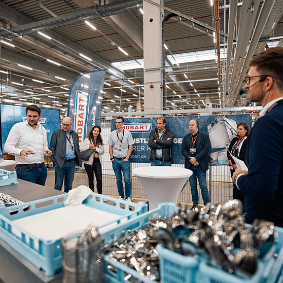 Presentation of HOBART components in an industrial setting with participants and blue sorting trays