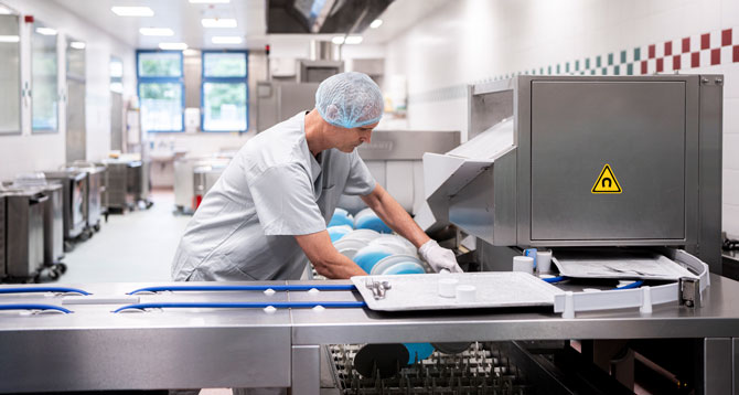 Close-up of the FLOW Line featuring a cutlery lifting magnet for automatic removal of cutlery from trays, ensuring hygienic and efficient workflow in professional warewashing systems.