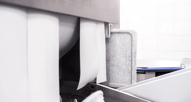Close-up of the FLOW Line featuring upright, space-saving tablet insertion; high-pressure nozzles ensure hygienic washing results, and a turbo blower provides optimal drying performance in professional warewashing.