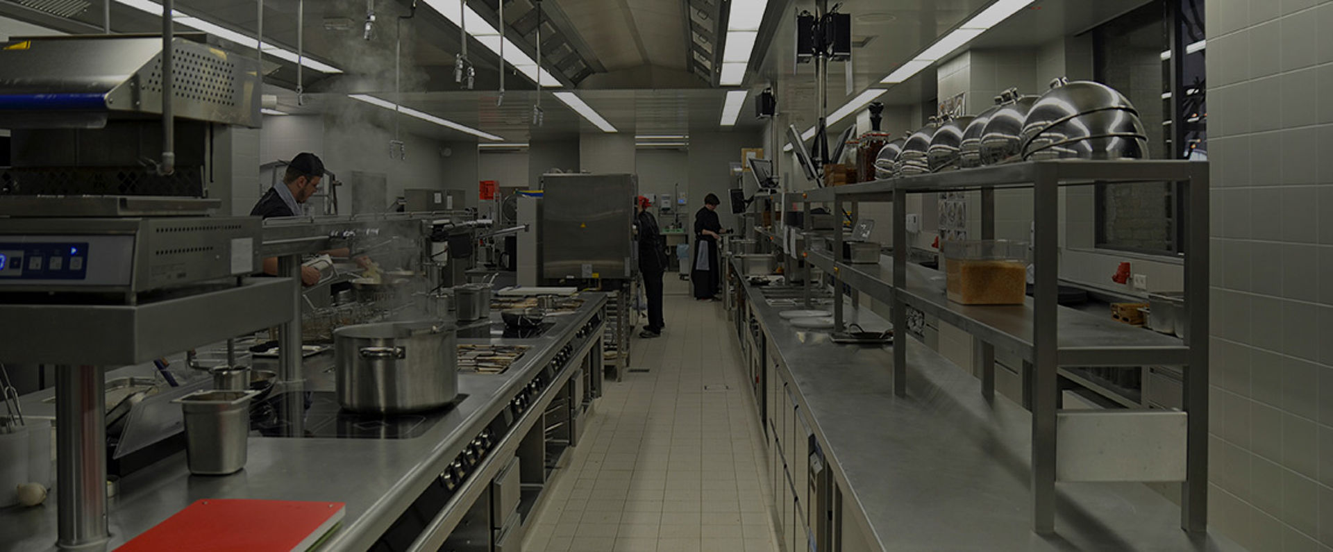 Professional kitchen at Stone Brewing Berlin featuring stainless steel workstations, cooking lines, ventilation systems, and organized preparation areas supporting high‑volume culinary operations.