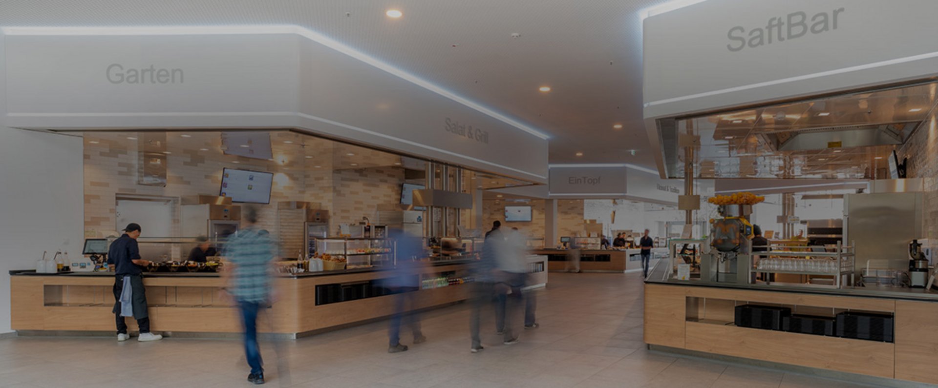 Modern food service stations in the MTU Aero Engines company restaurant, offering diverse meal options in a spacious and inviting dining environment.